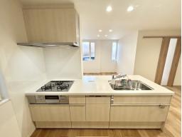 手元から足元までがすべてスライド式で収納力抜群のシステムキッチン。３口コンロ（無水両面焼きグリル）・食器洗い乾燥機・オールインワン浄水栓付きです。