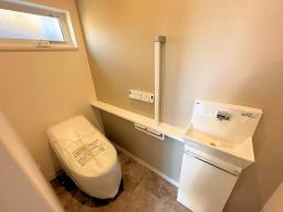 セパレートタイプの手洗い器が付いた、ローシルエットトイレでスッキリした印象のトイレ空間。